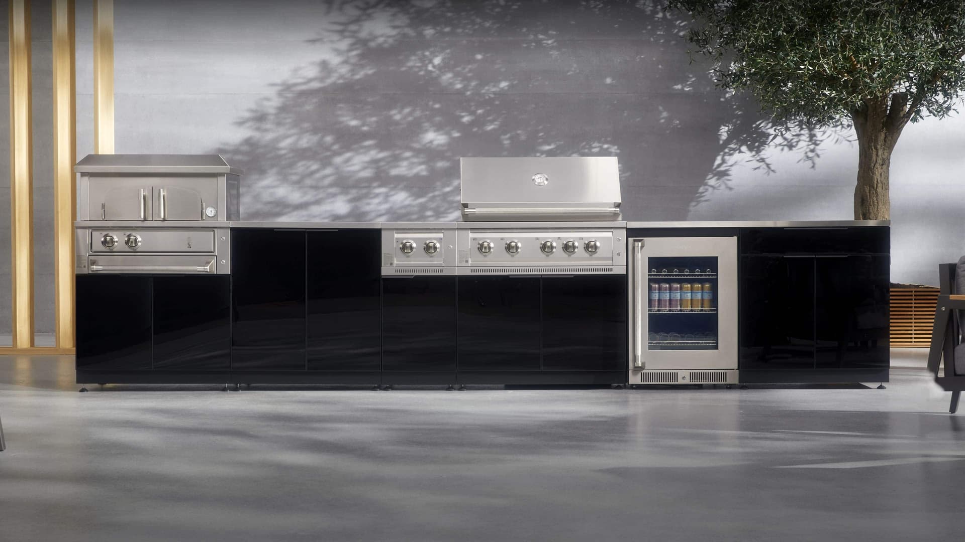 Modular NewAge outdoor kitchen island with built-in gas grill on a paved patio