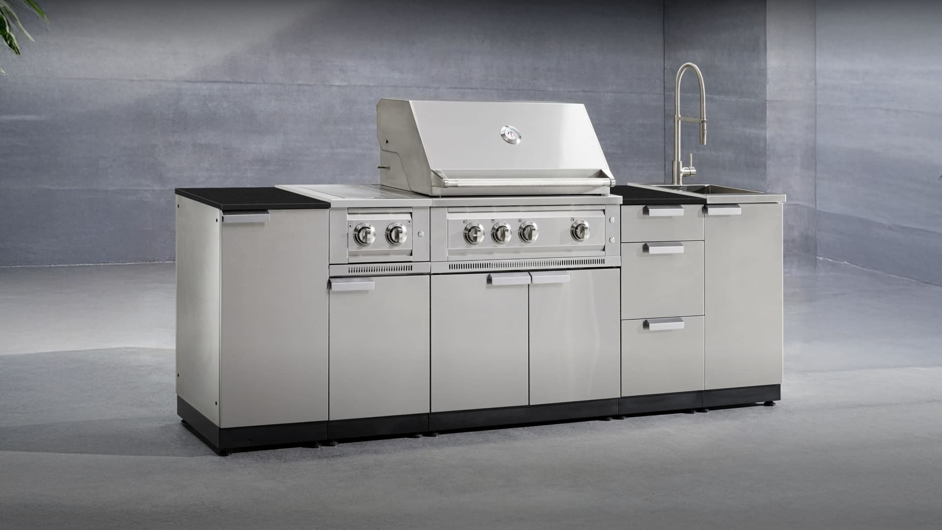 NewAge grill island with side burner and storage drawers on a backyard deck
